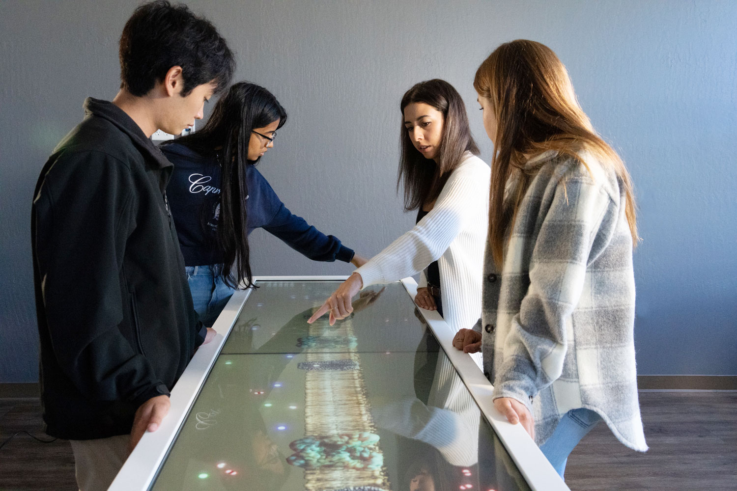 Students using Anatomage's interactive science technology in a high school science lab to perform virtual experiments and enhance STEM education.