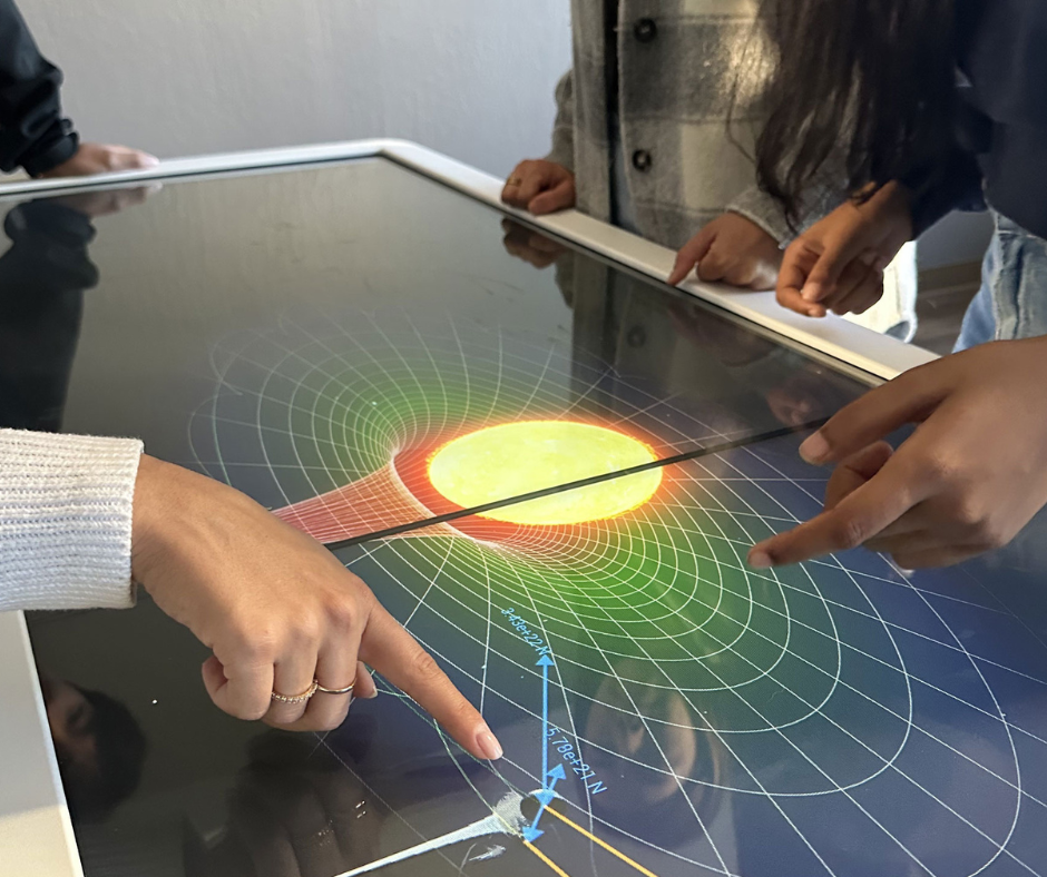 Students interacting with virtual science experiments using Anatomage’s touchscreen technology, designed for immersive and interactive STEM learning.